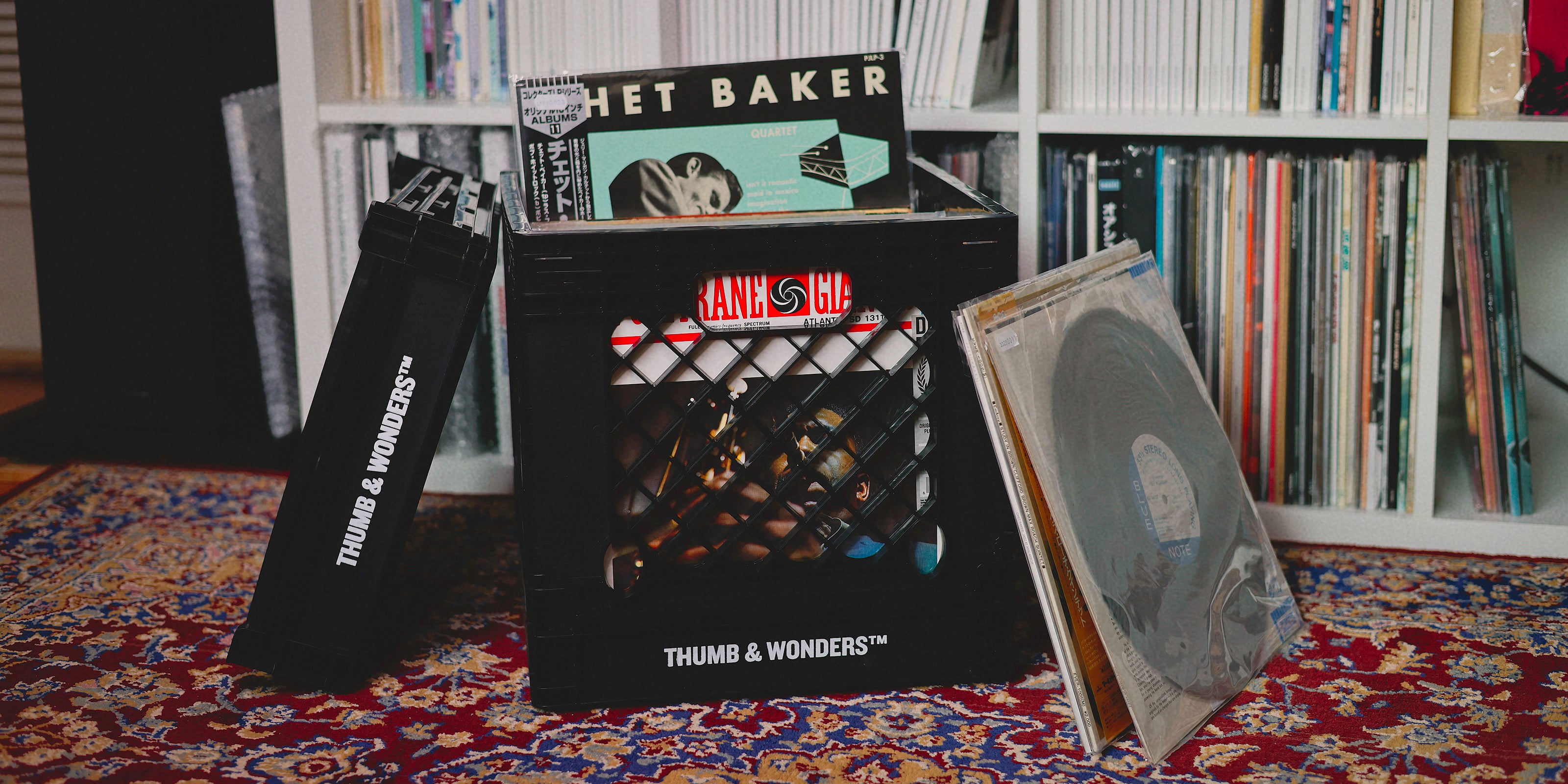 Thumb & Wonders record crate on a vintage rug, compatible with standard Disk Union crate dimensions, blending perfectly into a City Boy aesthetic music room.