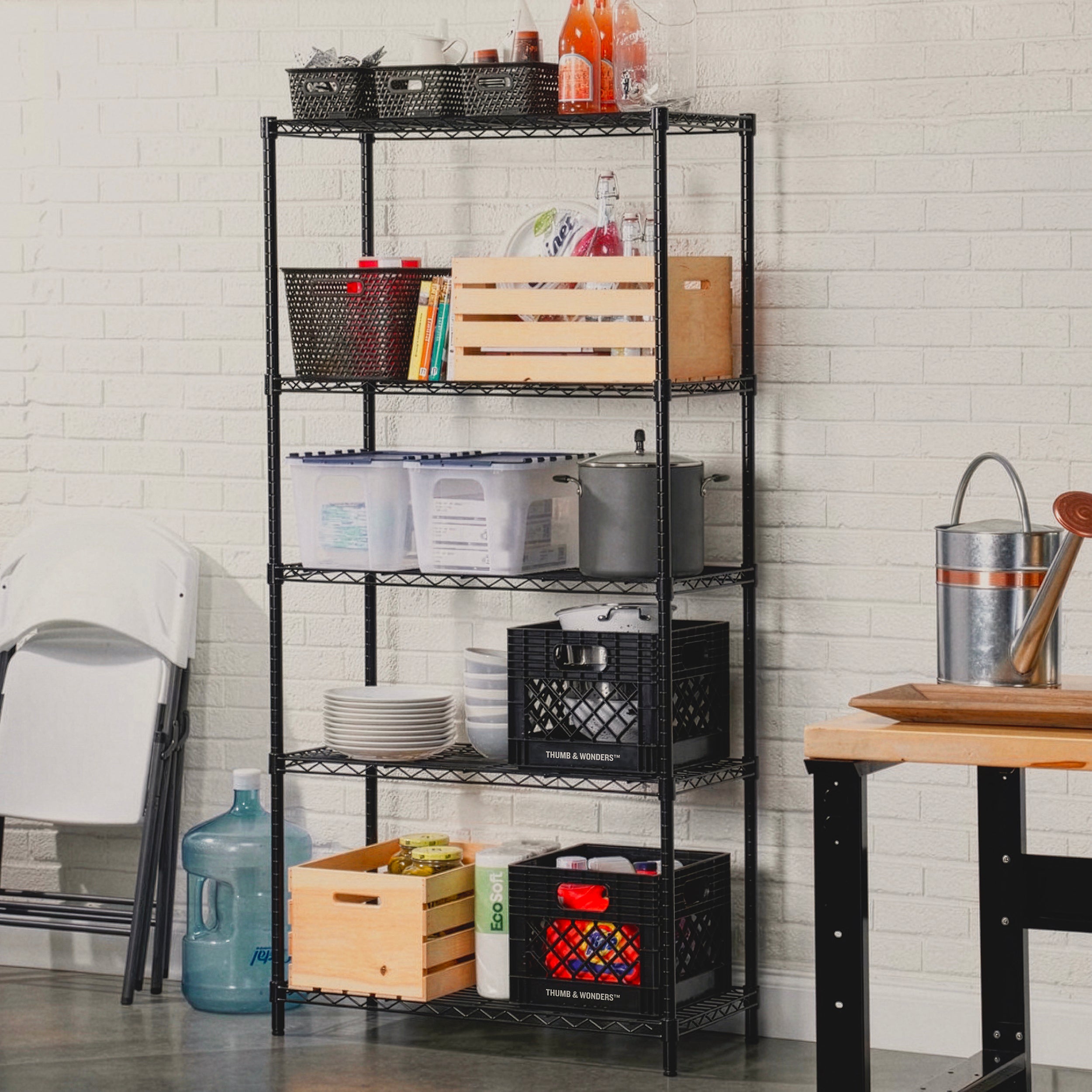 The ultimate home archive. Modern black metal shelving meets the textured detail of a white tiled wall, featuring Thumb & Wonders™ foldable crates for a clean, "City Boy" aesthetic that balances design twists with daily function.