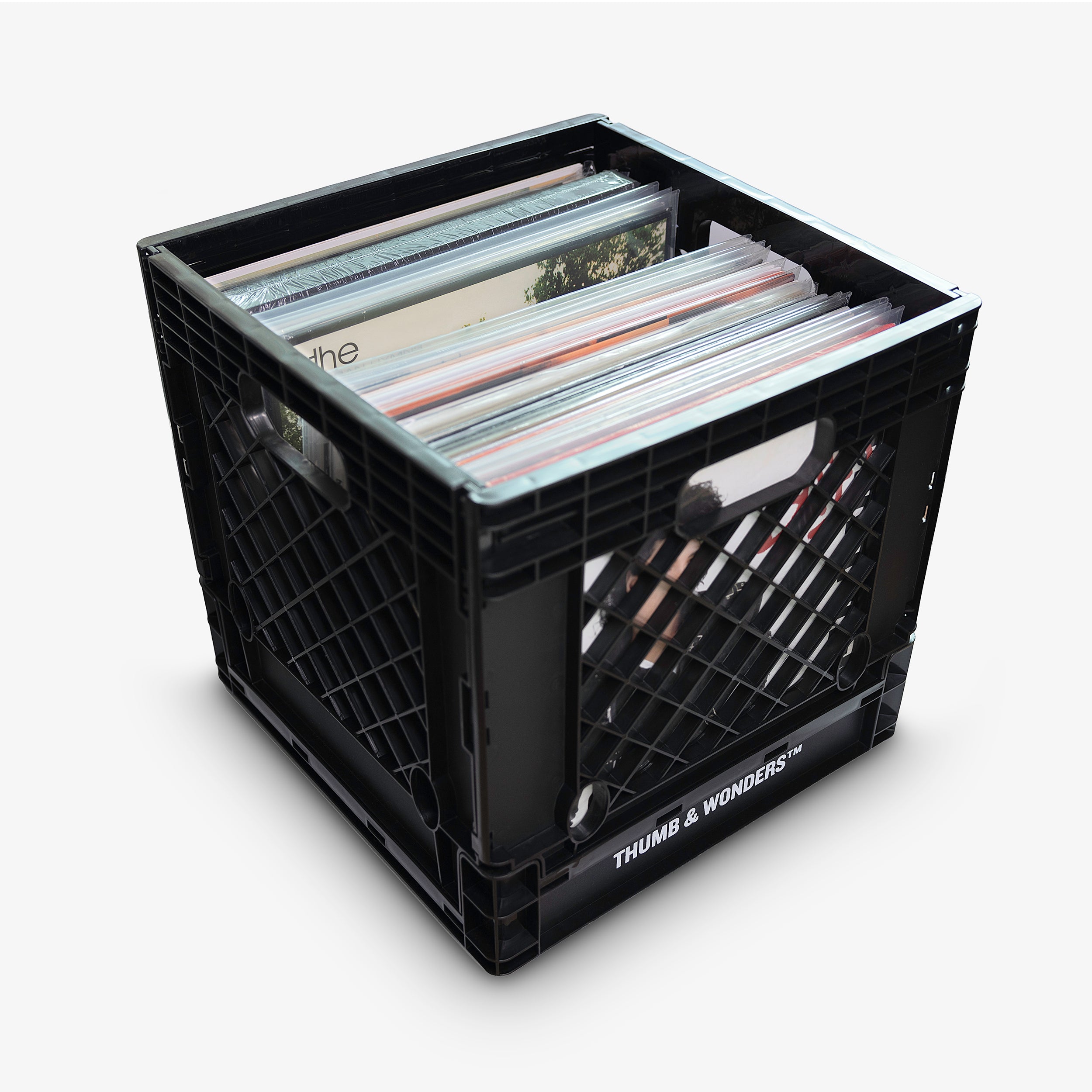 Thumb & Wonders premium black record crate filled with a curated vinyl collection, showcasing high-capacity storage on a clean minimalist background.