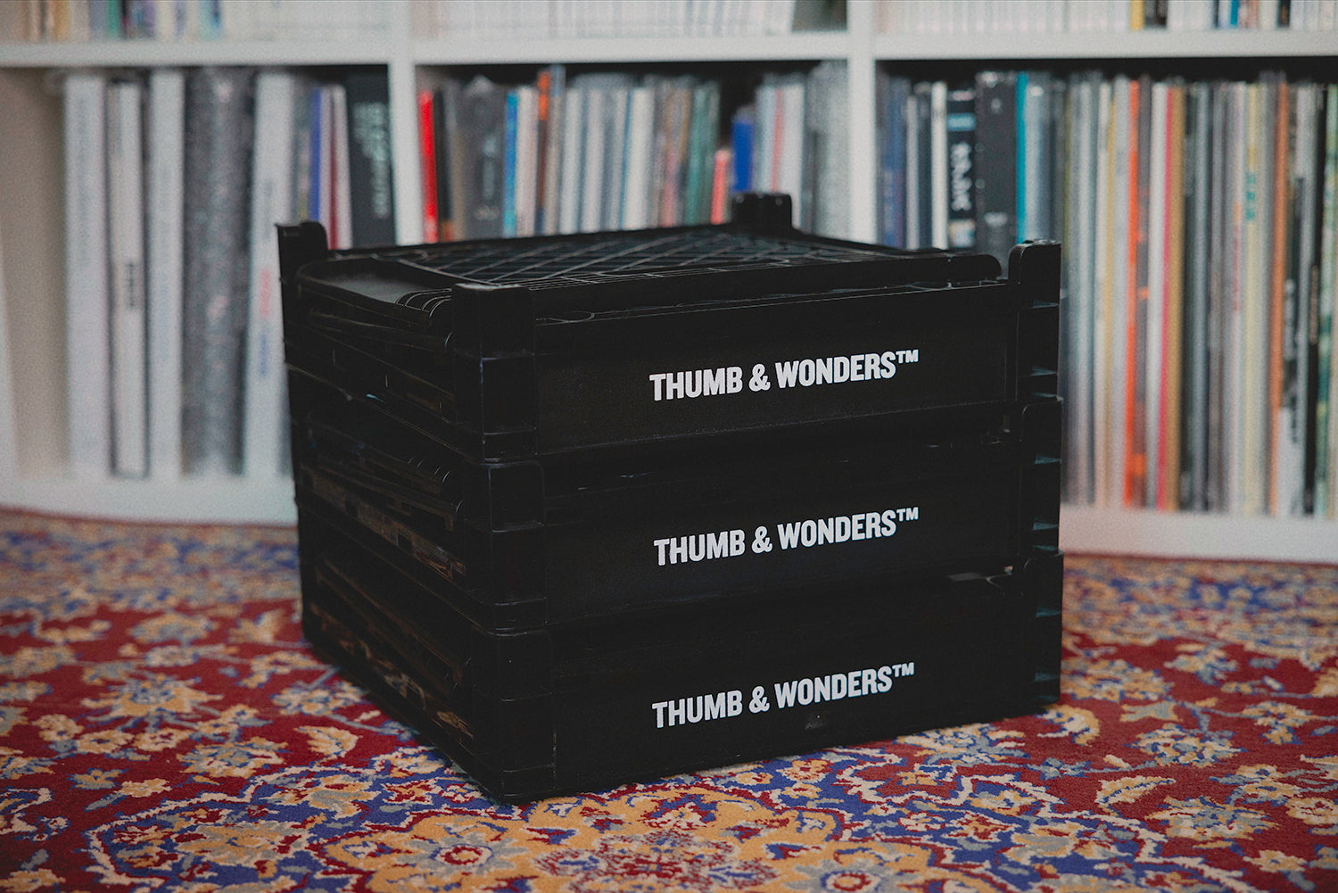 Three fully collapsed Thumb & Wonders storage crates stacked neatly, showcasing space-saving utility and a minimalist modular aesthetic for small interiors.